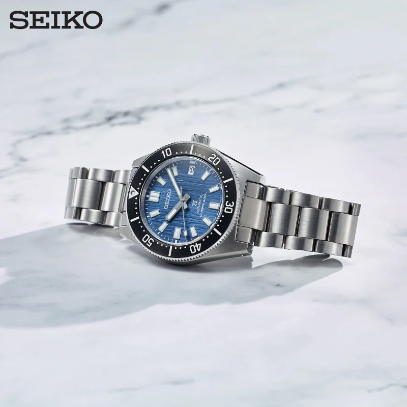 Seiko SPB297J1 Glacier — синий циферблат, стальной браслет на мраморной поверхности